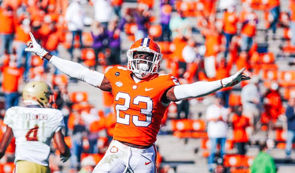 Andrew Booth of the Clemson Tigers Celebrates by extending his arms and pointing to the sky.