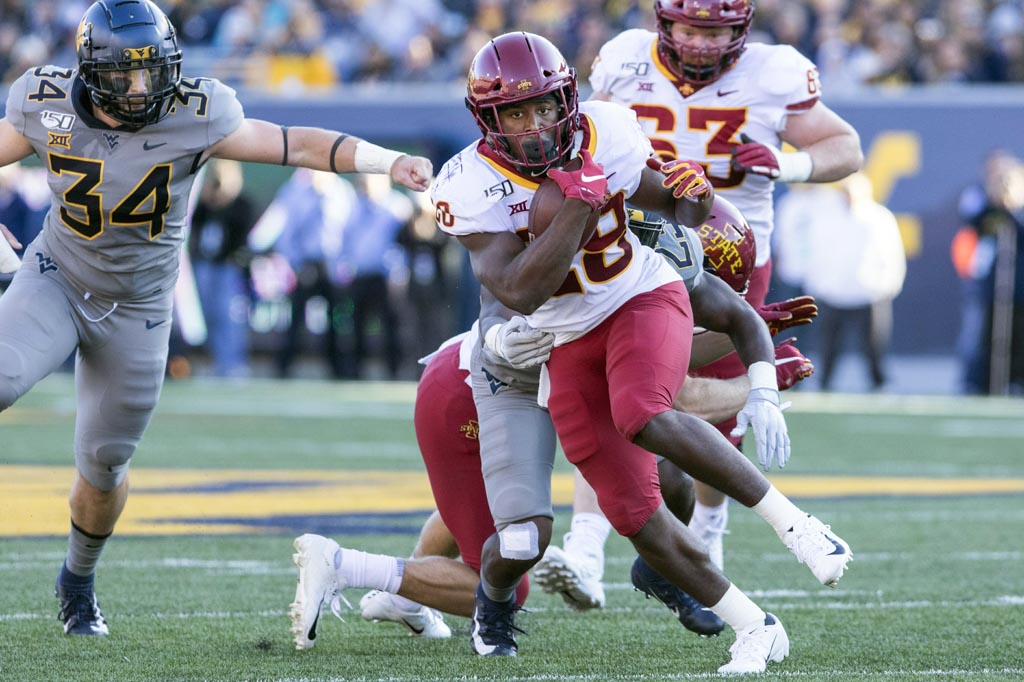 Iowa State Cyclones running back Breece Hall carries the ball while breaking a tackle.