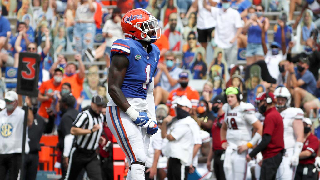 Brenton Cox pumps clenches his fists while celebrating during an NCAA Football game.