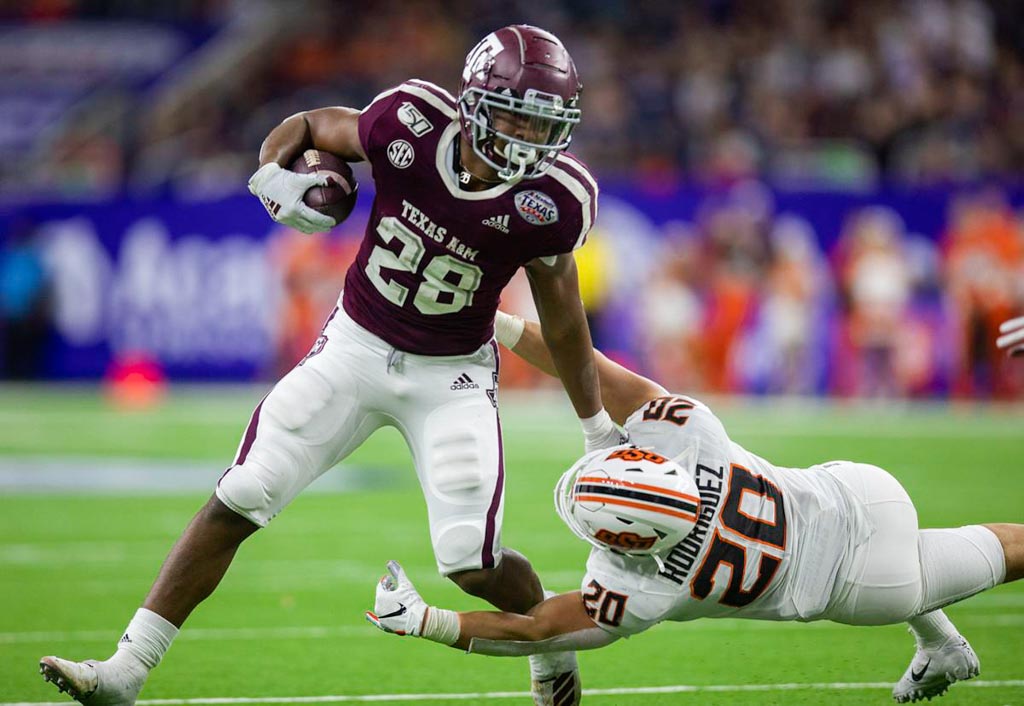 Texas A&M running back Isaiah Spiller breaking a tackle.