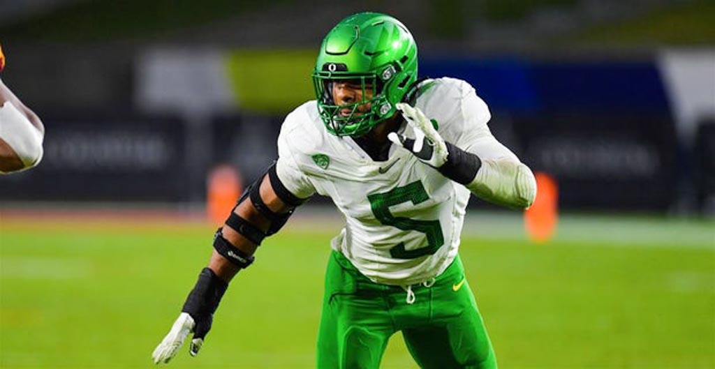 Oregon Ducks defensive end Kayvon Thibodeaux wearing white and green.