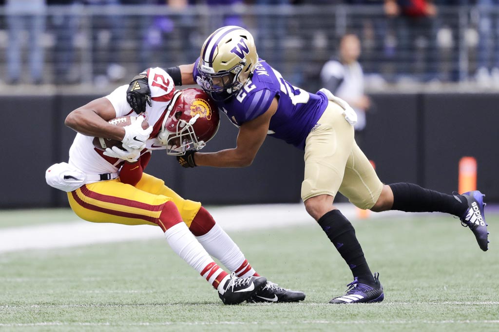 Washington Huskies cornerback Trent McDuffie tackles a USC receiver.