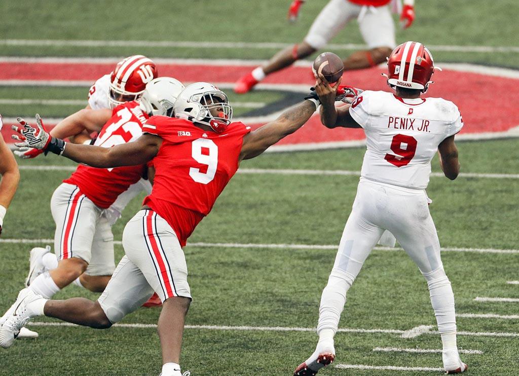 Buckeyes defensive end Zach Harrison stripping the ball from the Indiana QB.